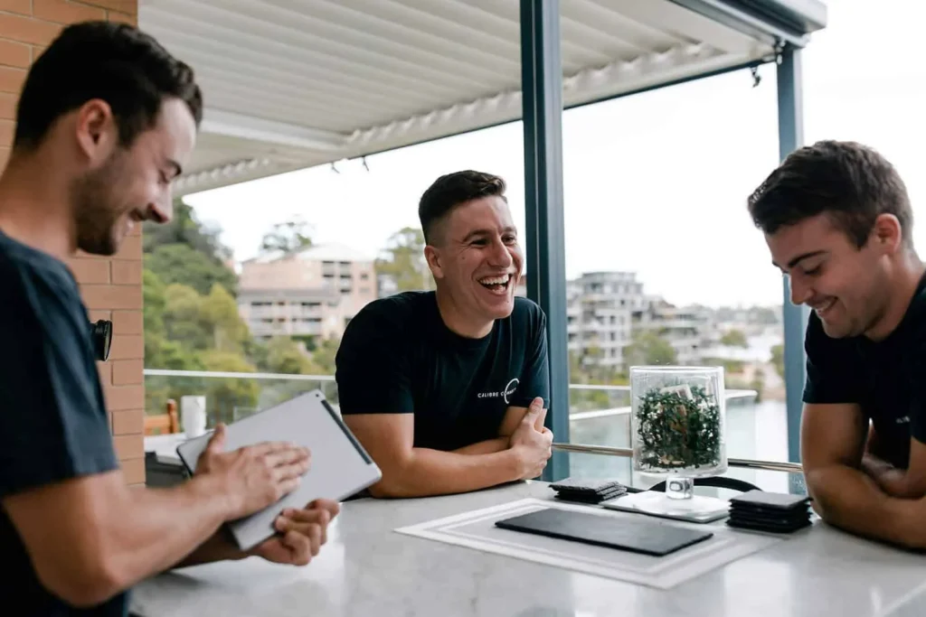 Licensed and insured Calibre Connect electricians discussing a residential electrical service plan in Sydney