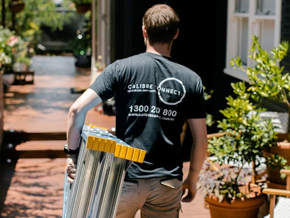 Calibre Connect electrician arriving at a residential property with a ladder for electrical service