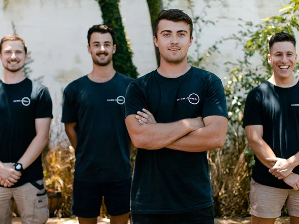 Calibre Connect electricians team standing together in branded uniforms