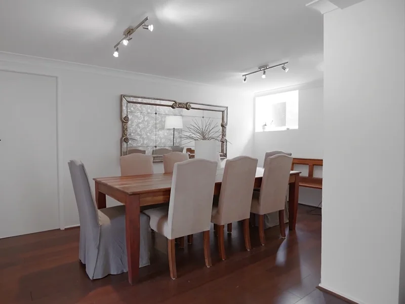 Ceiling track lighting installed above dining table at Stafford Place, North Turramurra