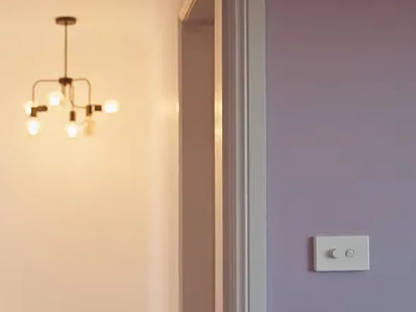 Wall-mounted dimmer switch installation beside bedroom doorway at Minter Street, Canterbury