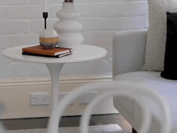 Double power point installed on wall beneath side table in living area at Young Street, Annandale