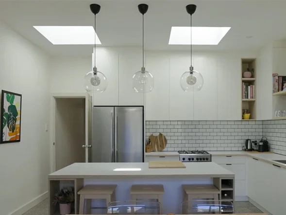 Modern kitchen with glass pendant light installation over island bench at Yelverton Street, Sydenham