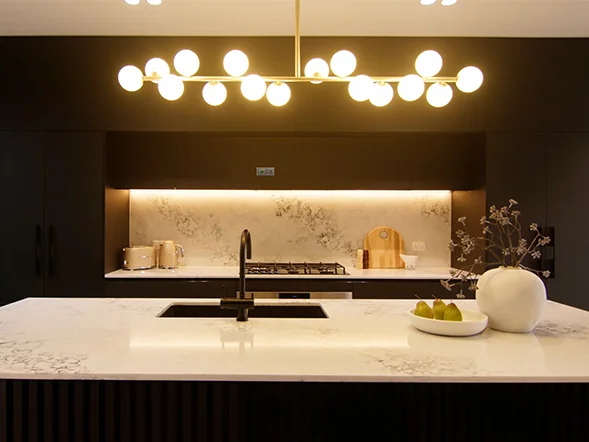 Modern linear pendant light installation over kitchen island at Mackenzie Street, Concord West
