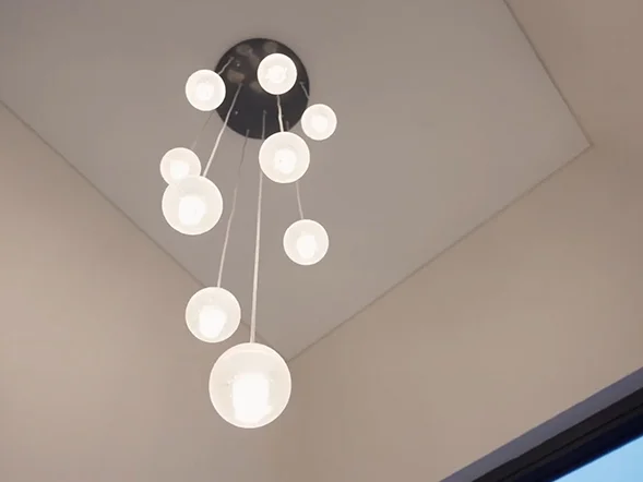 Modern multi-drop pendant light with glass globe bulbs suspended from ceiling at Walker Street, Rhodes