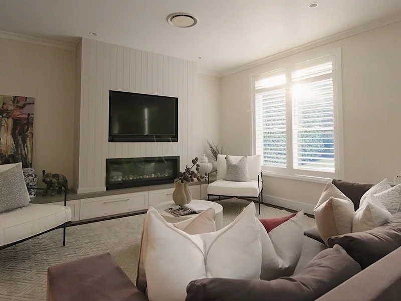 Wall-mounted television installation above fireplace in modern living room at Gamma Road, Lane Cove