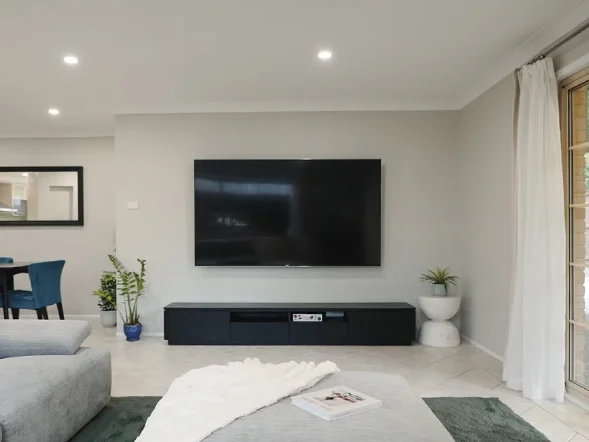 Wall mounted television installation in modern living room at Forest Close, Cherrybrook