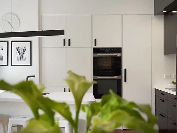 Built-in wall oven seamlessly integrated within custom white cabinetry at Belmore Street, Rozelle
