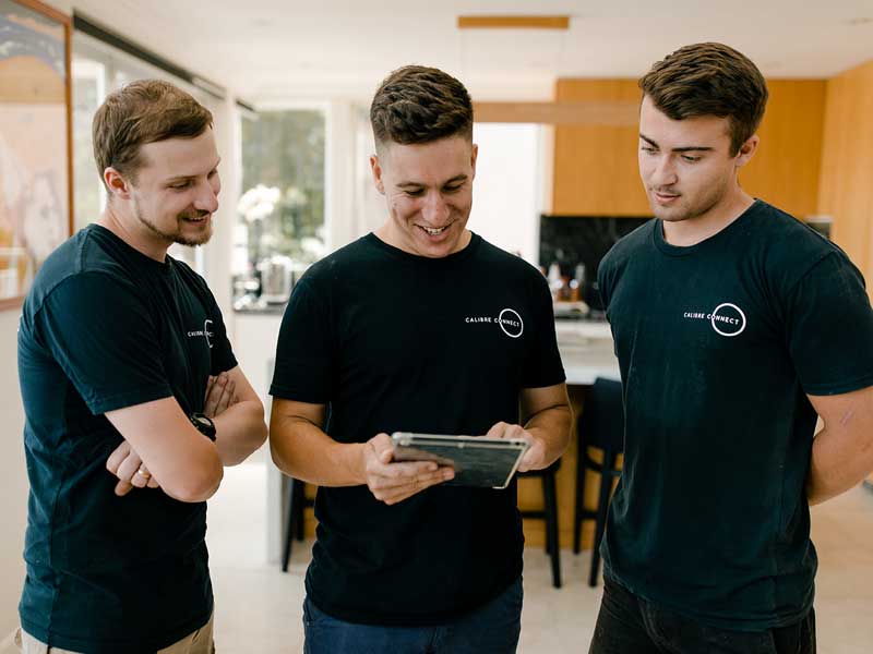 Calibre Connect electricians reviewing electrical work scope on-site before preparing a quote