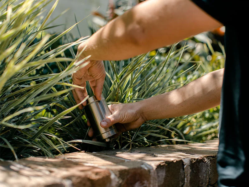 Installing stainless steel IP-rated garden spike light in outdoor garden bed