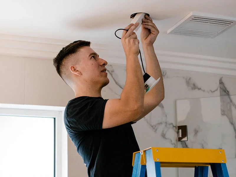 Calibre Connect electrician installing IC-rated LED downlight in insulated ceiling