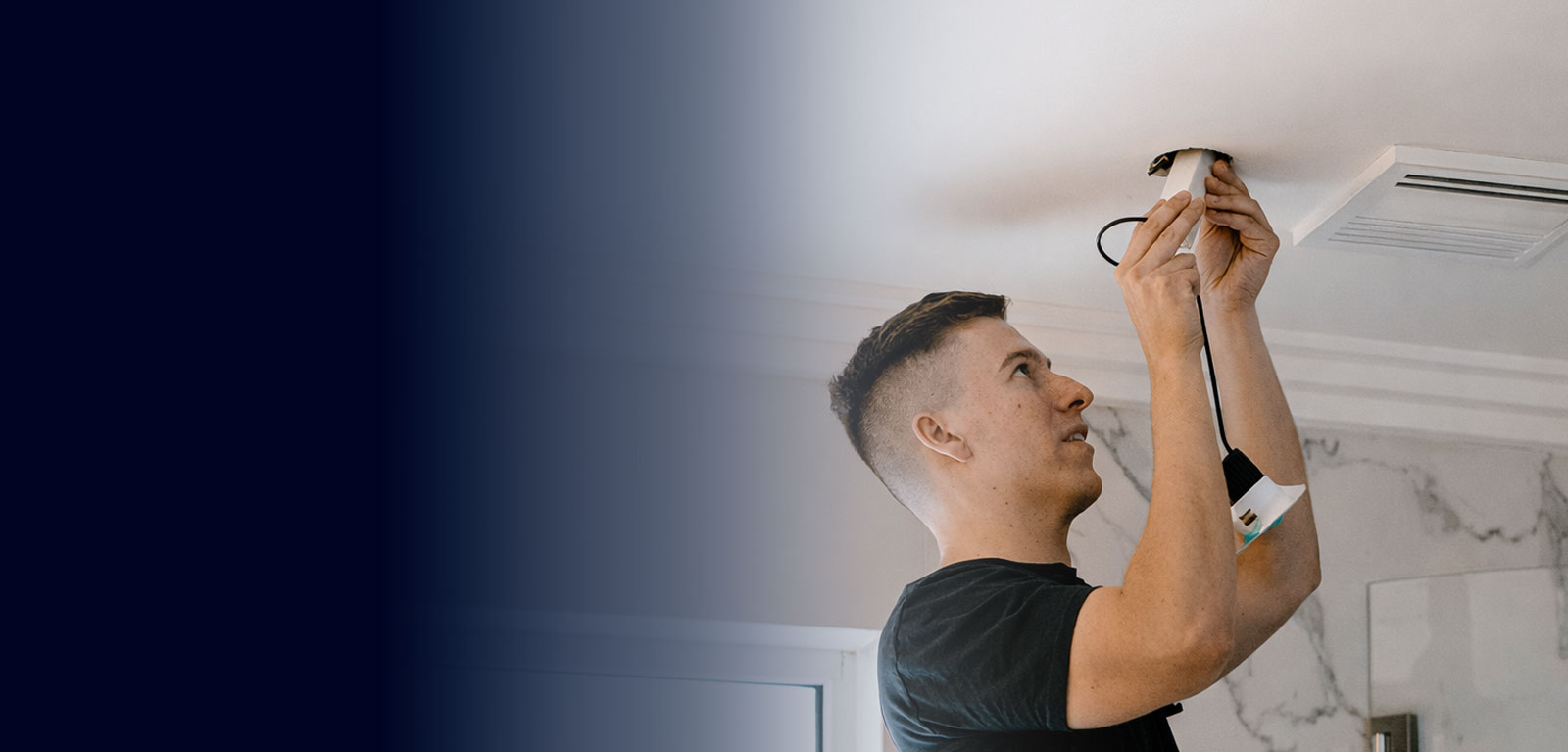 Calibre Connect electrician installing IC-rated LED downlight in insulated ceiling