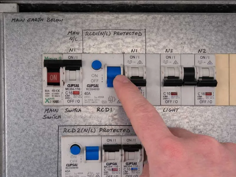 Calibre Connect electrician resetting an RCD safety switch on a residential switchboard in Sydney