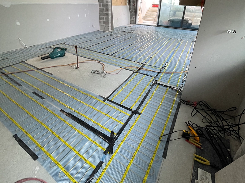 Electric underfloor heating mats installed beneath an apartment floor in Sydney