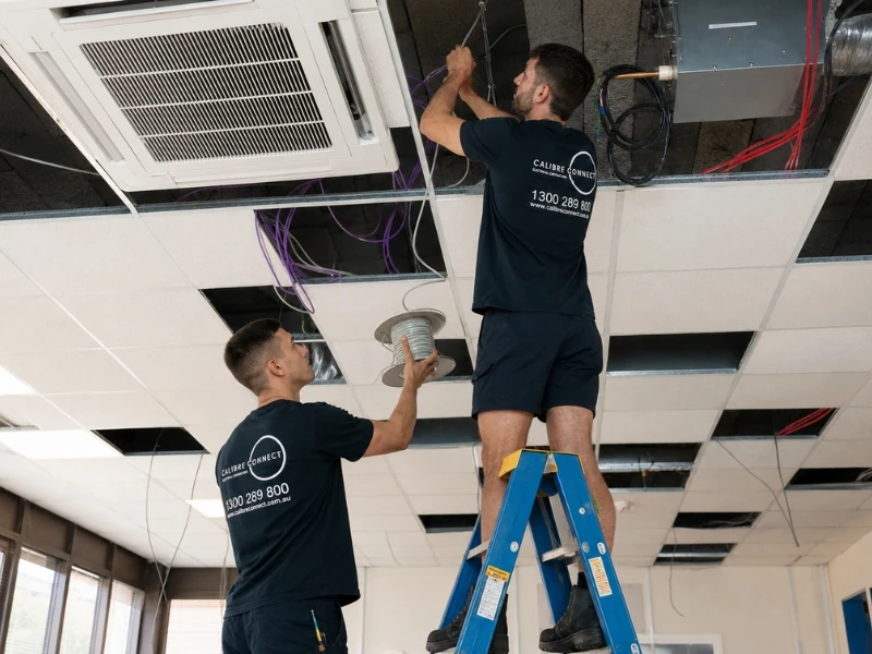 Calibre Connect electricians inspecting ceiling wiring and cabling during an electrical safety inspection in Sydney