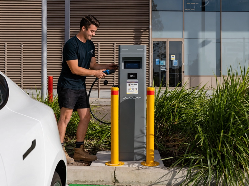 Calibre Connect electrician checking a commercial EV charger before handover at a Sydney property