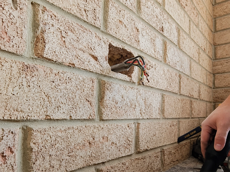 Double brick wall chased for concealed power point wiring in a Sydney property