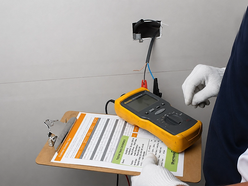 Electric underfloor heating system being tested and commissioned by an electrician in Sydney