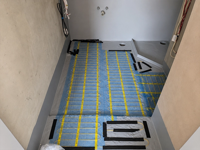 Electric underfloor heating mats installed beneath an ensuite floor in a Sydney home