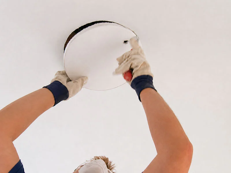 Calibre Connect cutting a gyprock ceiling opening for a ceiling fan installation in Sydney