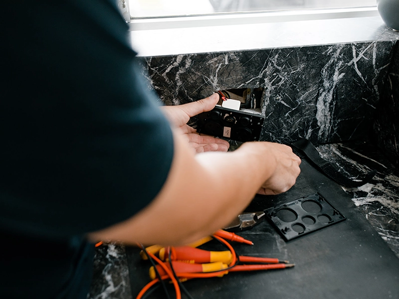 Electrician installing a kitchen power point for appliance and dedicated circuit planning in Sydney