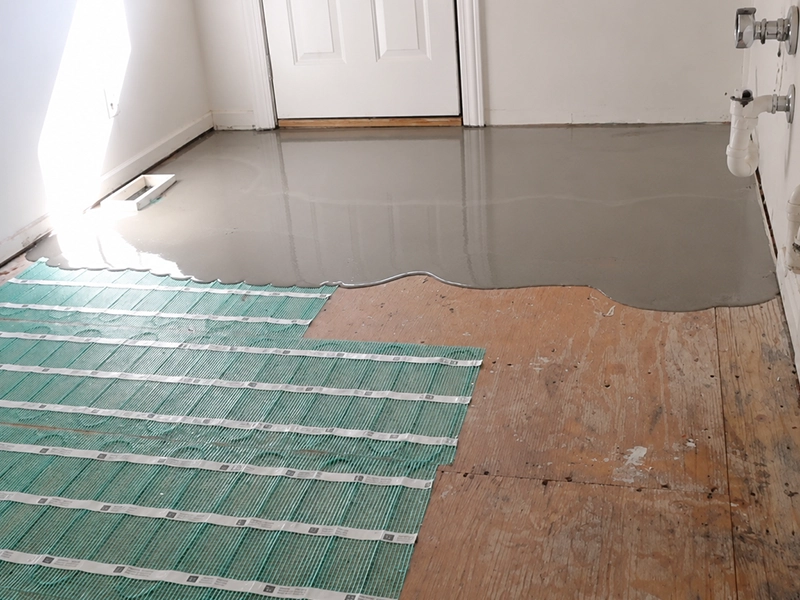 Electric underfloor heating mat installed beneath a laundry floor in a Sydney home