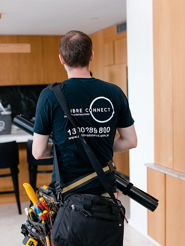 Licensed electrician carrying lighting equipment for LED downlight installation in a Sydney property