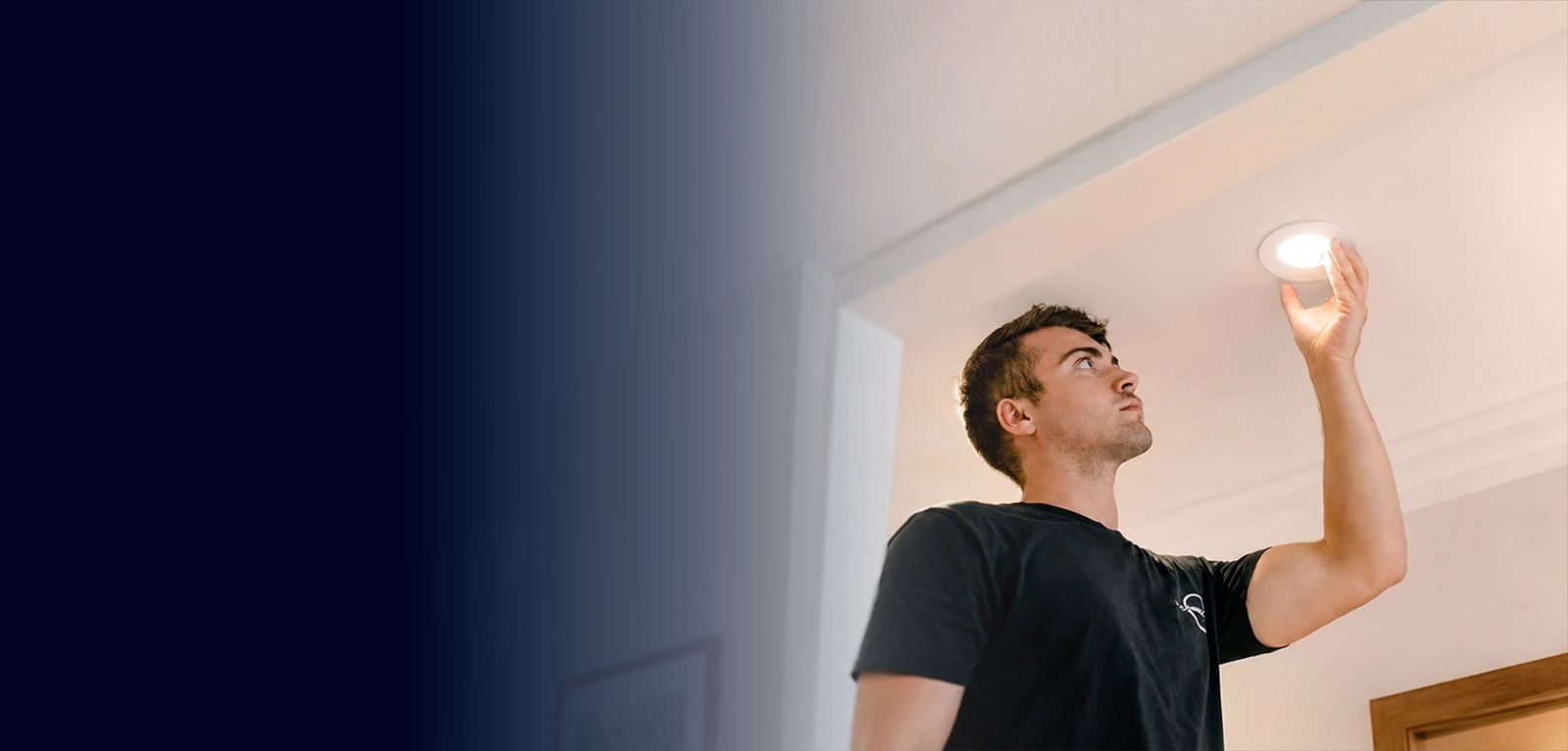 Licensed electrician installing LED downlights in a residential property in Sydney