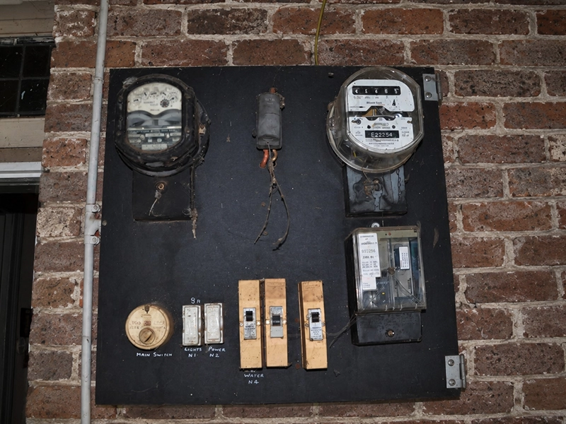 Old meter board and switchboard panel requiring careful assessment for asbestos concerns in Sydney