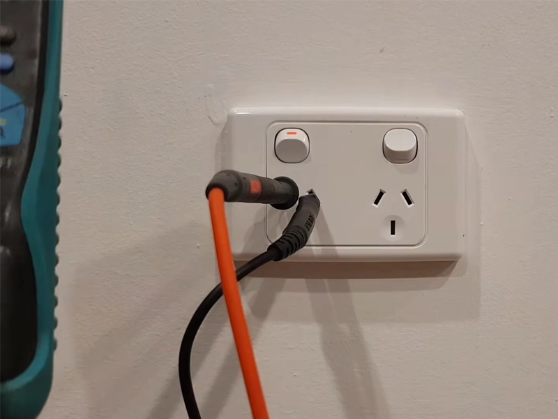 Double power point being tested for safe operation in a Sydney property