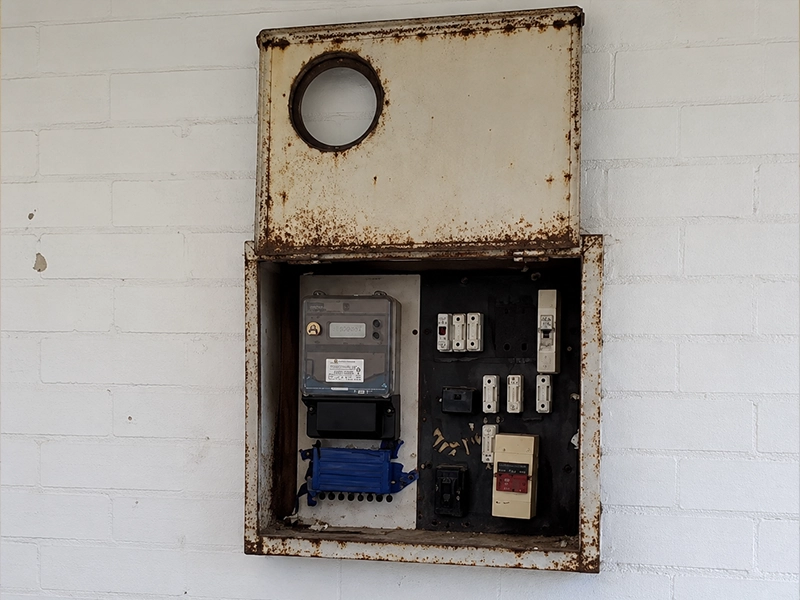 Rusted electrical switchboard with signs of water damage requiring upgrade in Sydney