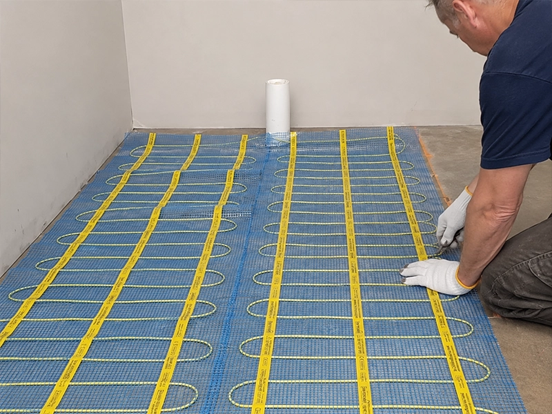Electric underfloor heating mat layout being planned before the floor is covered in a Sydney home