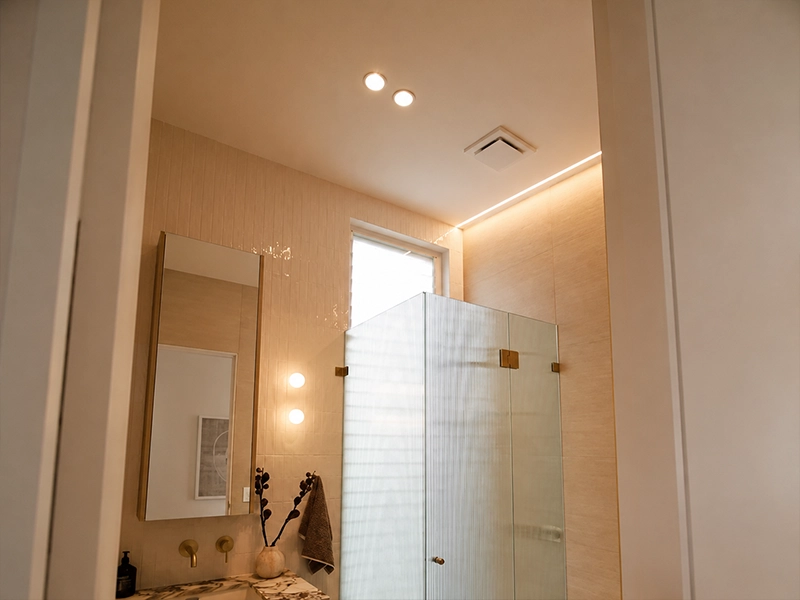 Bathroom wet-area lighting with LED downlights and mirror lights in a Sydney home